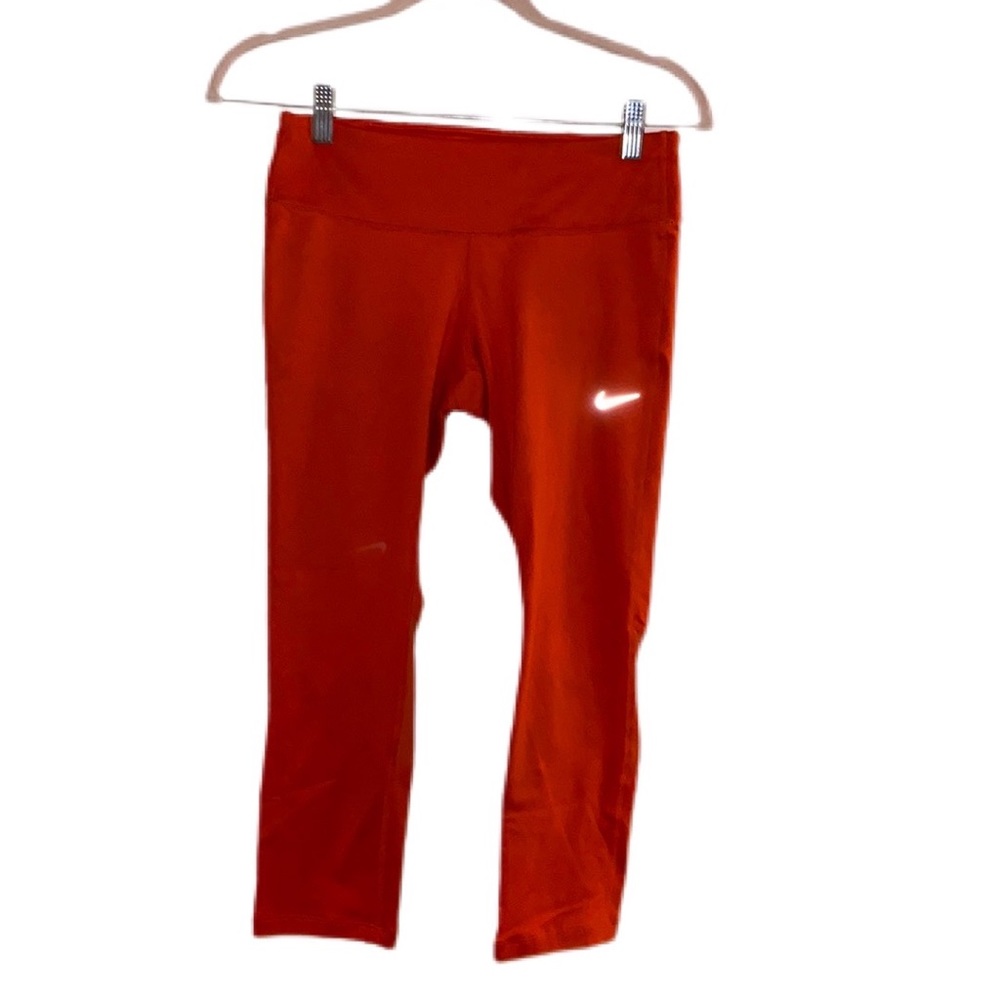 Nike Dri-Fit Sports Leggings, orange/reddish in color, size small.